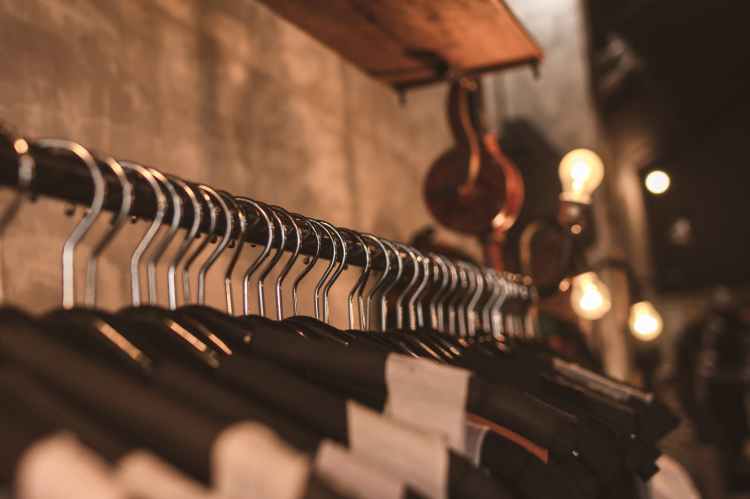 photo of black clothes on hangers